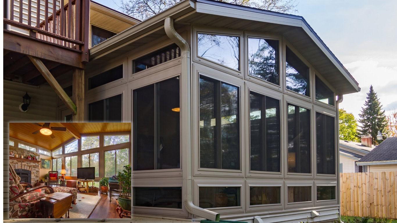 Exterior shot of a multi-pane custom four-season sunroom or porch enclosure during autumn, featuring a small inset image displaying the warm interior living room with stone fireplace and hardwood floors.